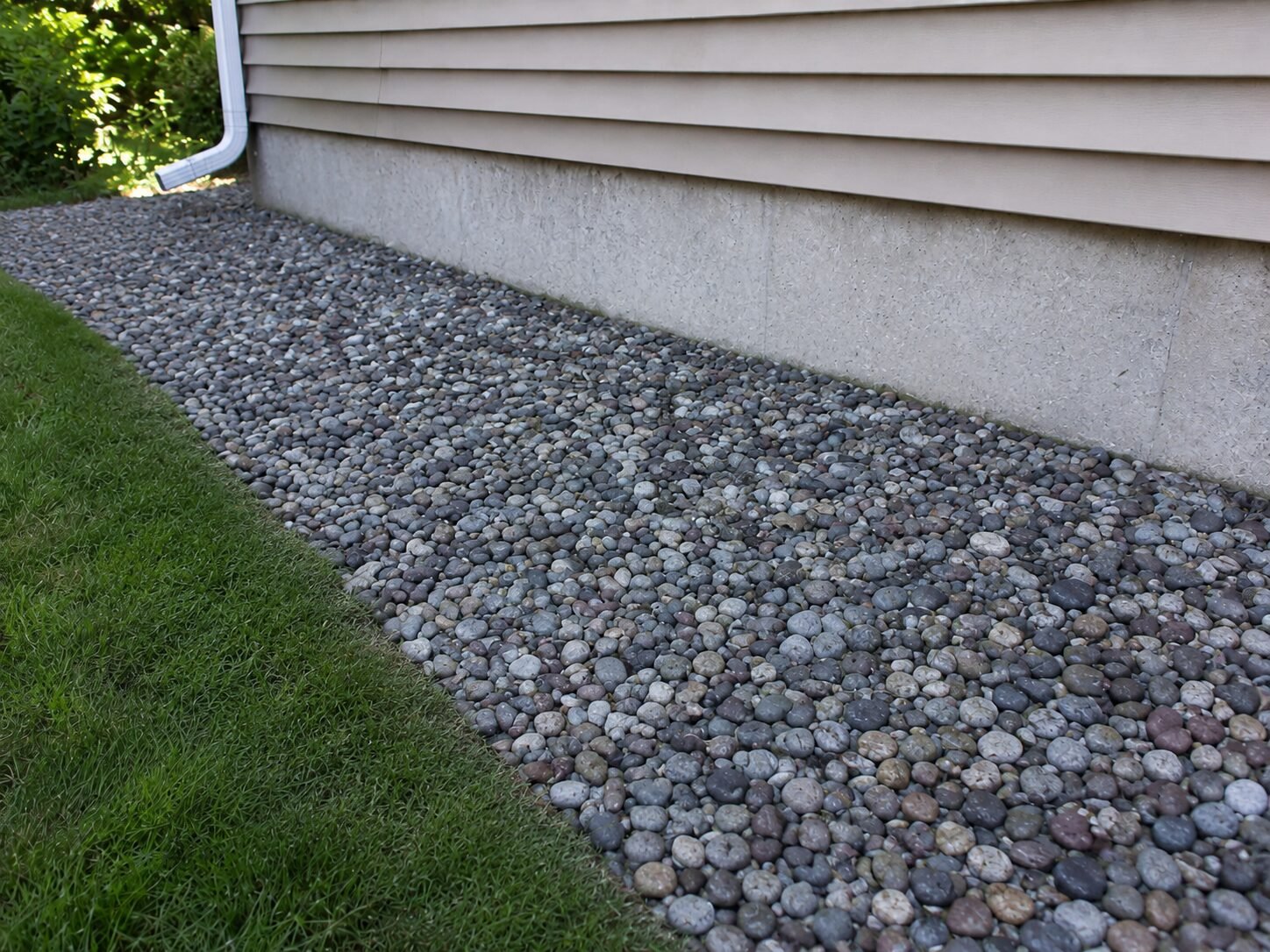 After — cleared, weed-free rock mulch bed
